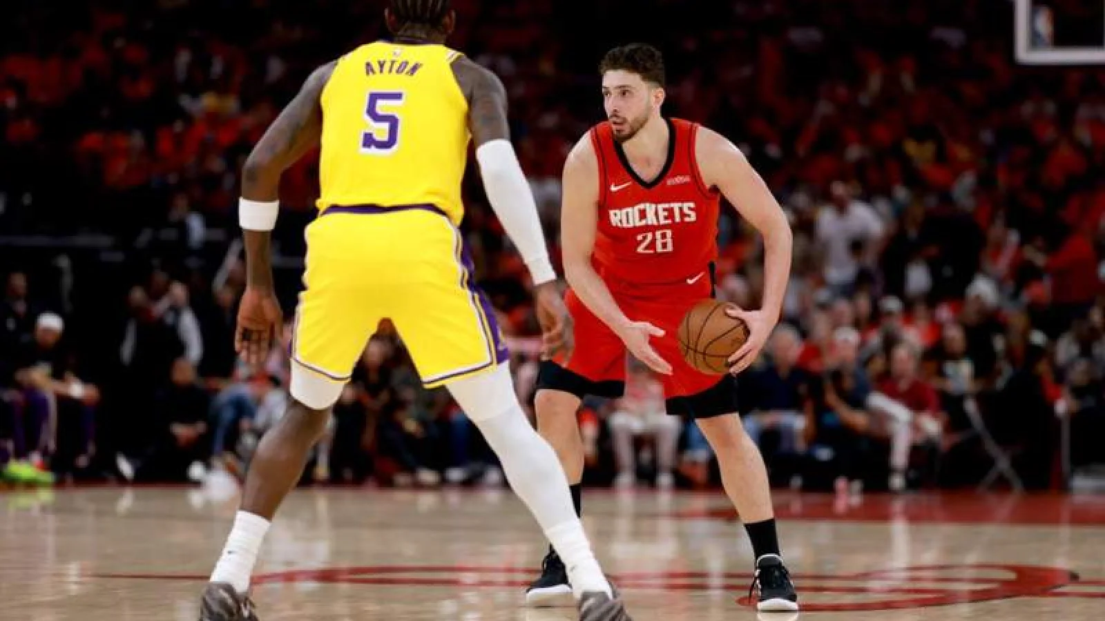 Deandre Ayton and Alperen Sengun battle for position in the paint during a physical NBA playoff game