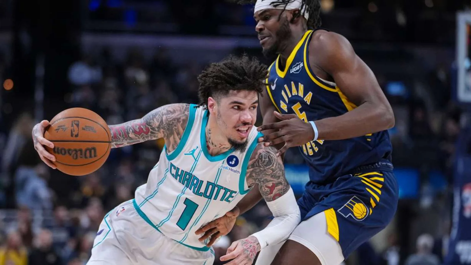 NBA guard bringing the ball up the court during a game